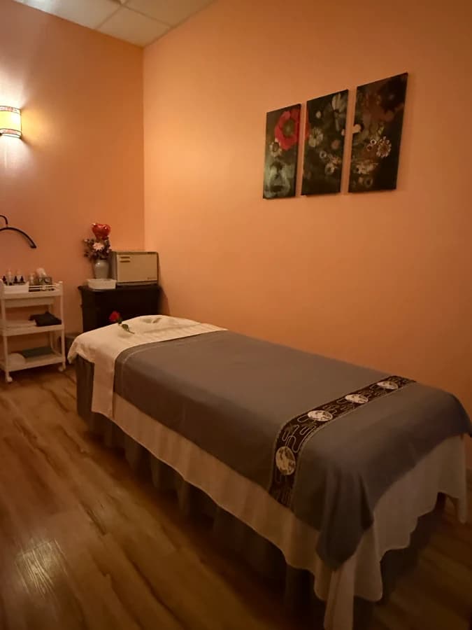 Relaxing Massage Room With Rose On Table